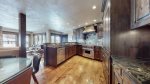 Gourmet fully equipped kitchen with granite countertops and stainless steel appliances